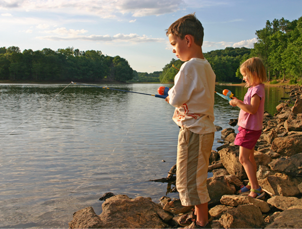 Two kids fishing on a lake
