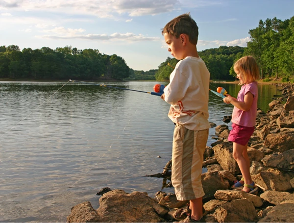 Two kids fishing on a lake